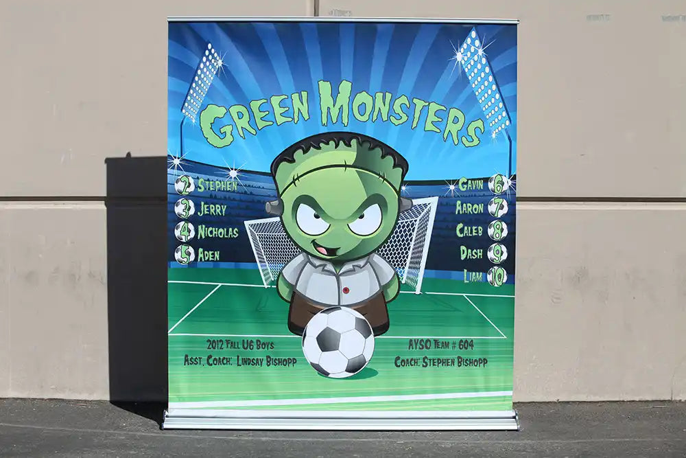 Cartoon illustration of a green monster soccer player with a Frankenstein-style appearance holding a soccer ball.