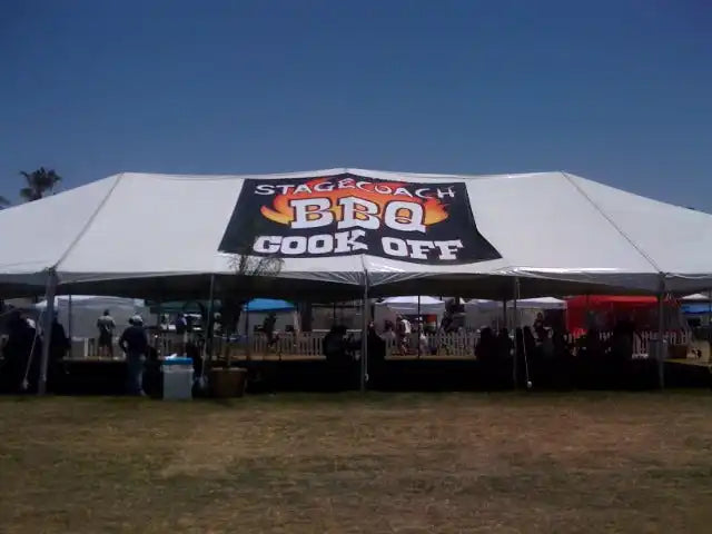 White tent with a ’BBQ Cook Off’ banner across the top.